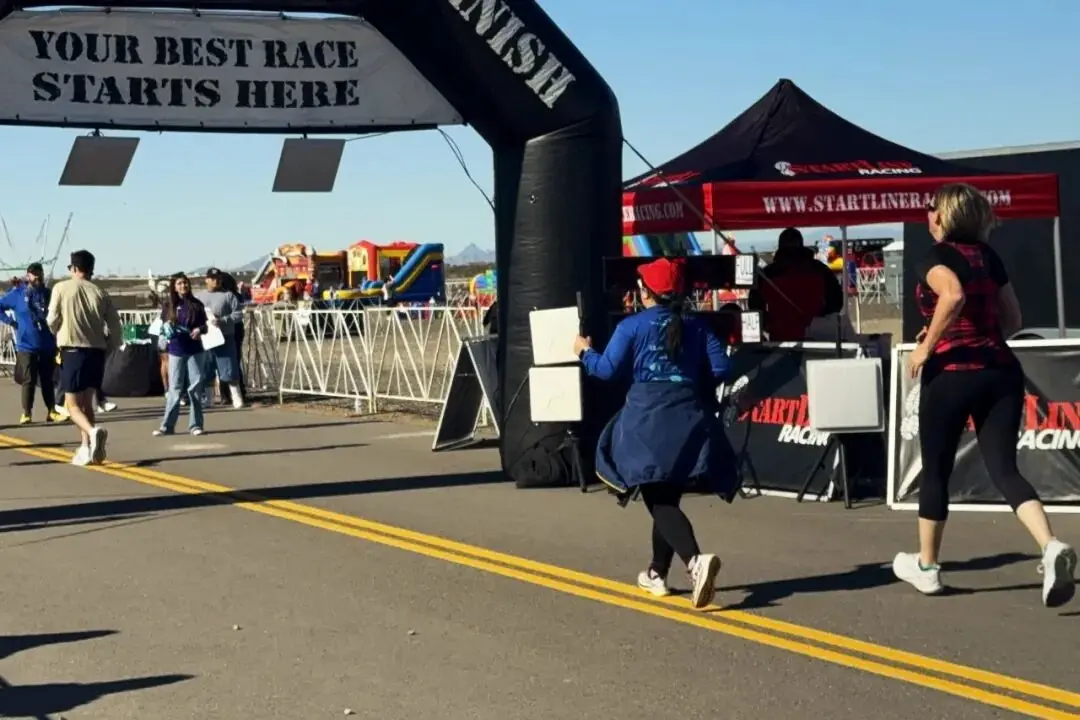 Runners and volunteers in the finish area