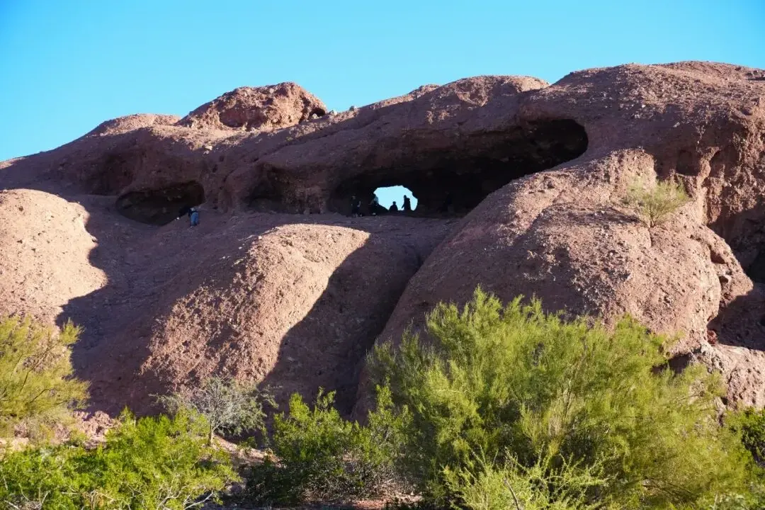 Visitors silhouetted at Hole-in-the-Rock
