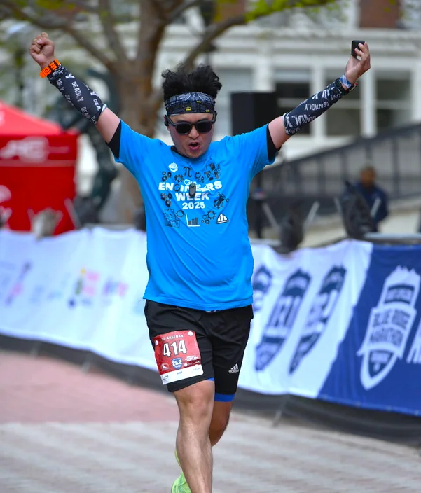 Official finish-line photo with both arms raised