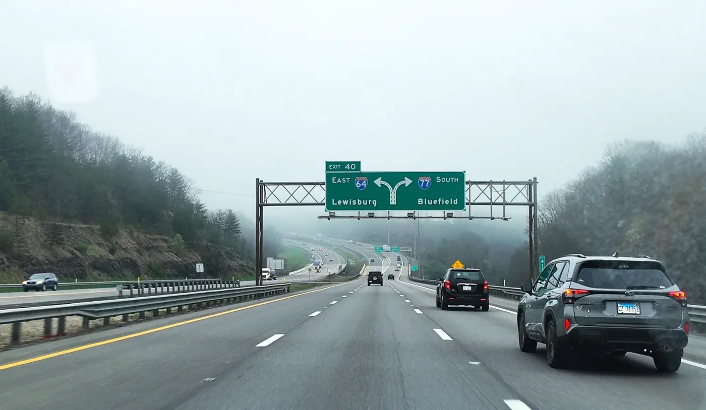 Foggy road sign on the mountain highway