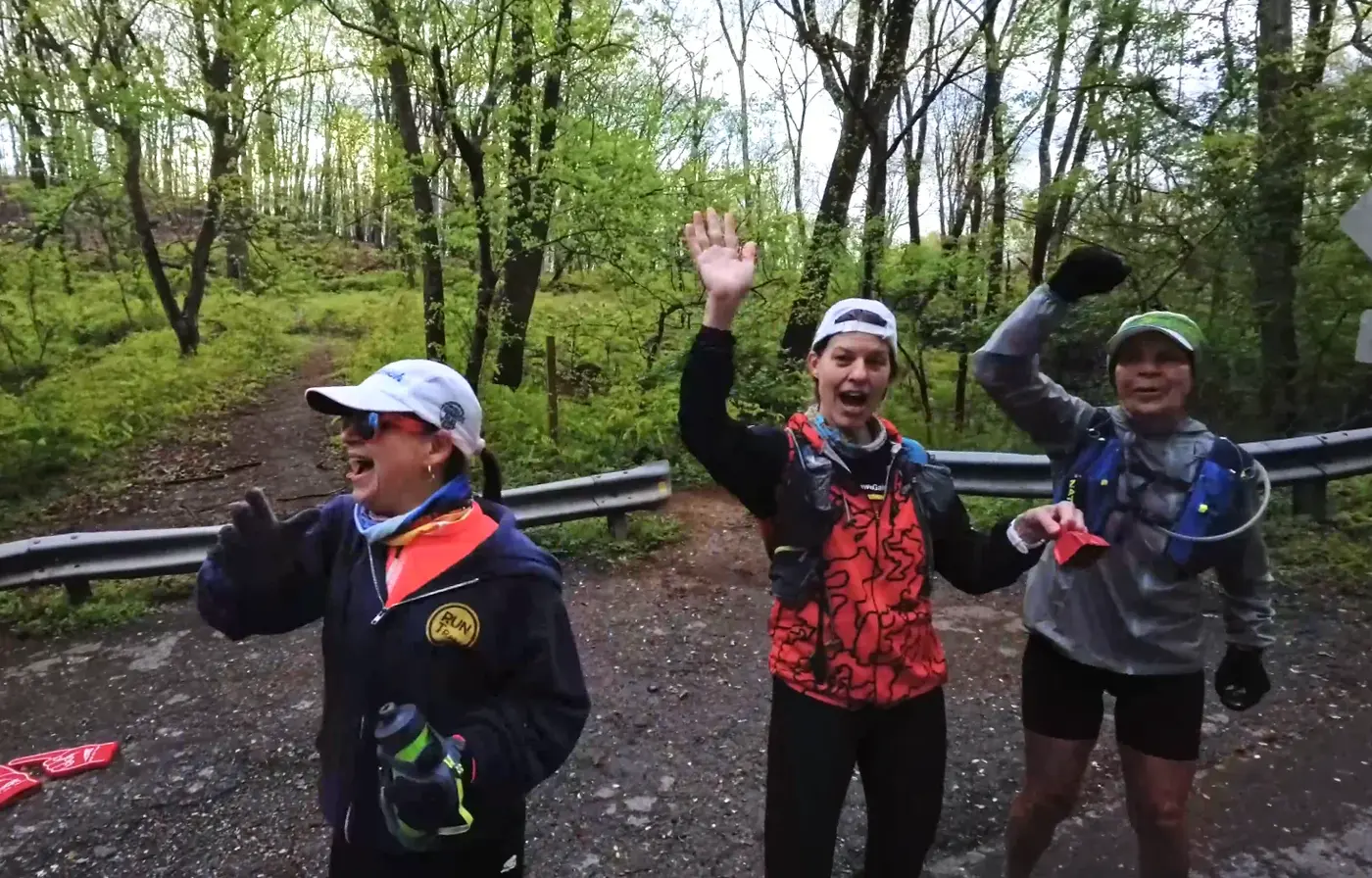 Trail runners smiling on the climb