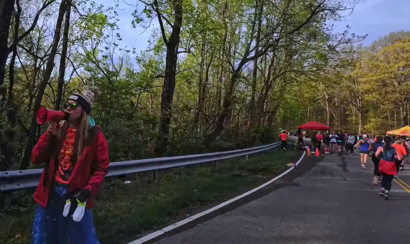 Spectator in red on the mountain shoulder