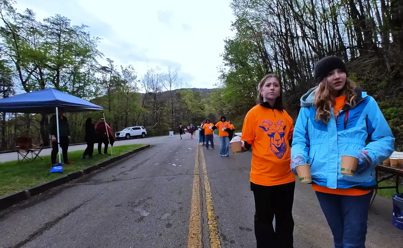 Volunteers in orange and blue layers