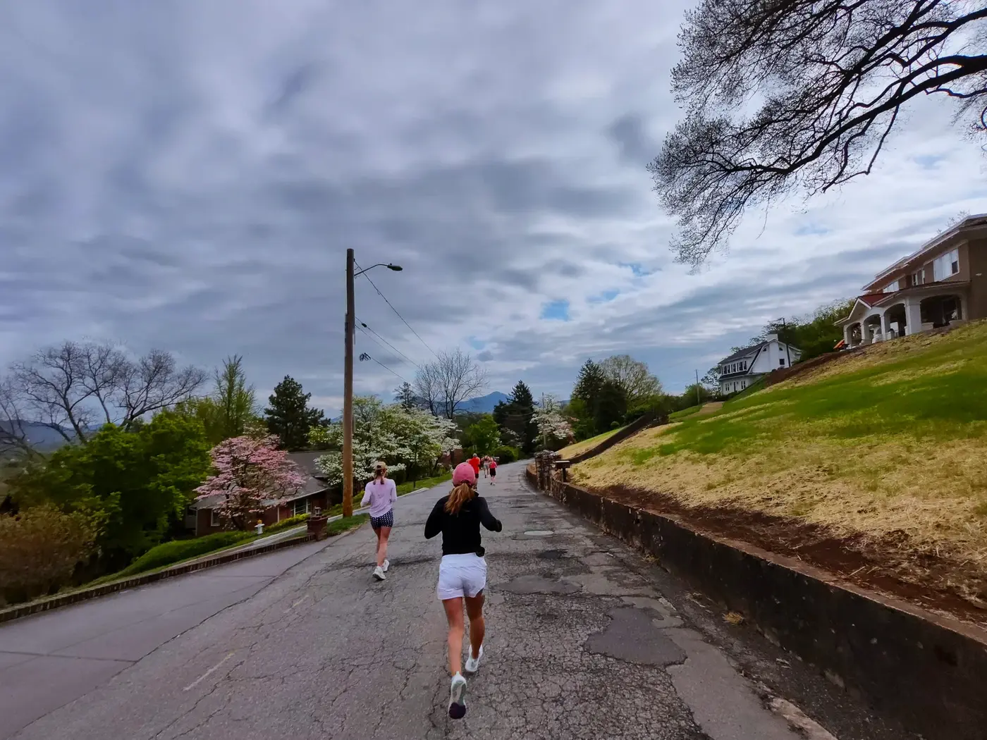 Runner climbing under a heavy sky