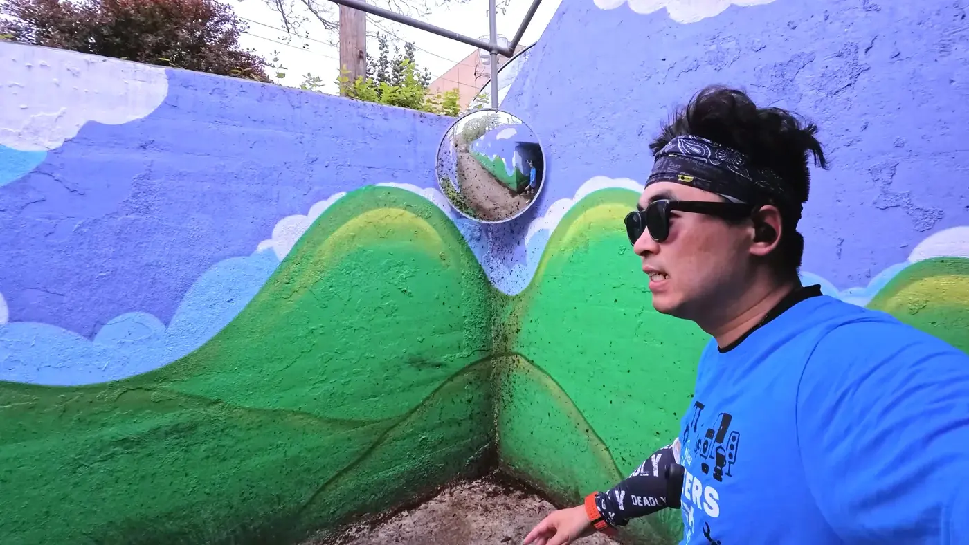 Selfie beside the wave mural