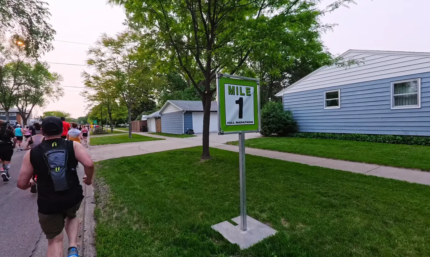 Mile 1 sign in front of a blue house