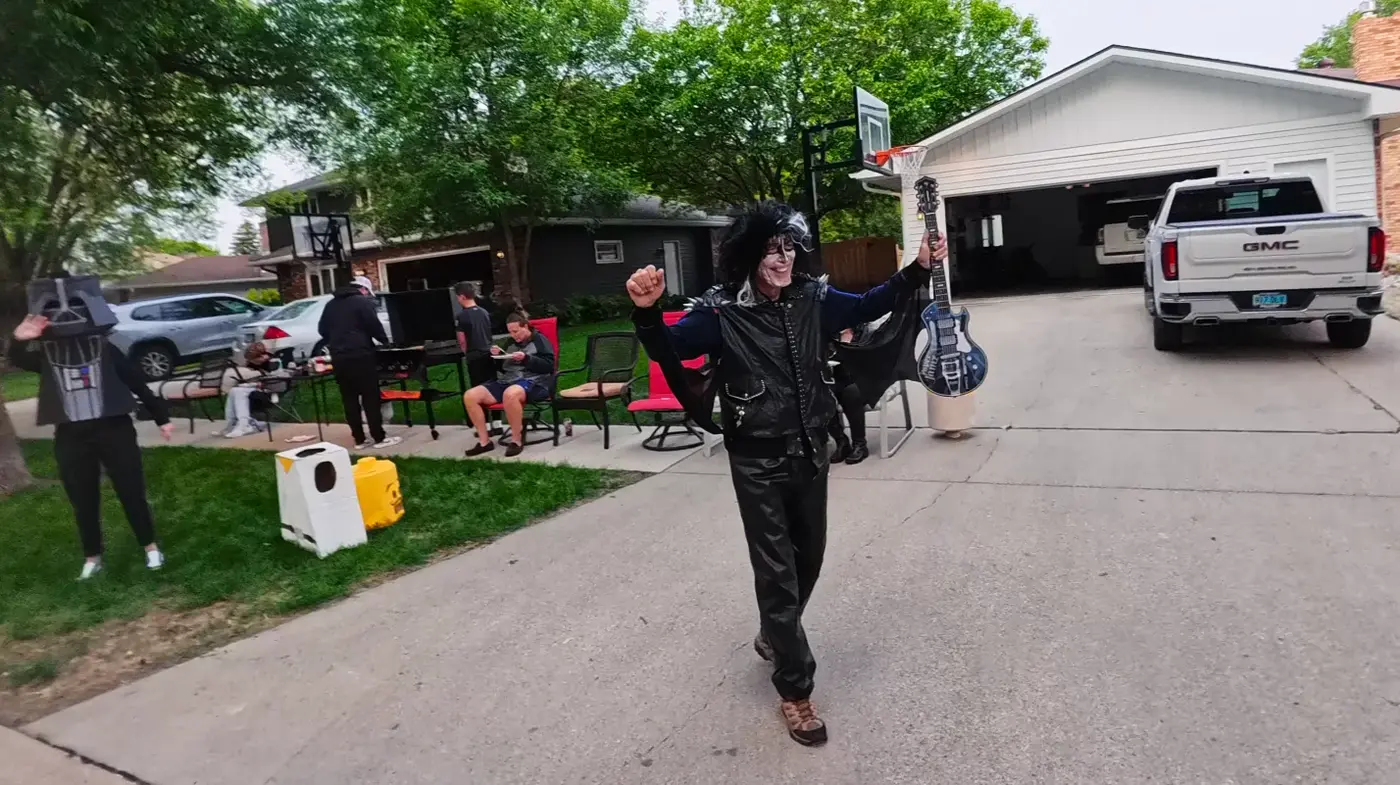Air-guitar cheerleader in a driveway