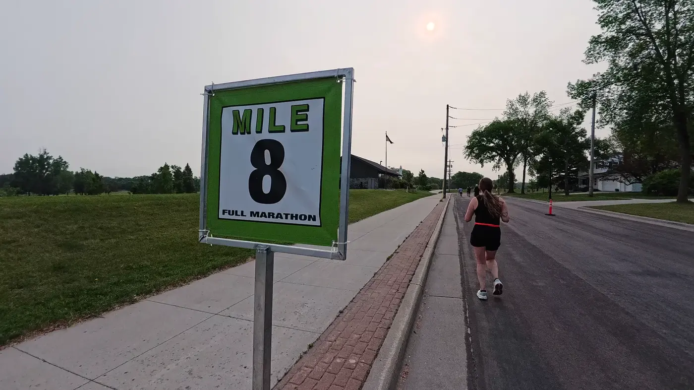 Mile 8 sign beside the open road