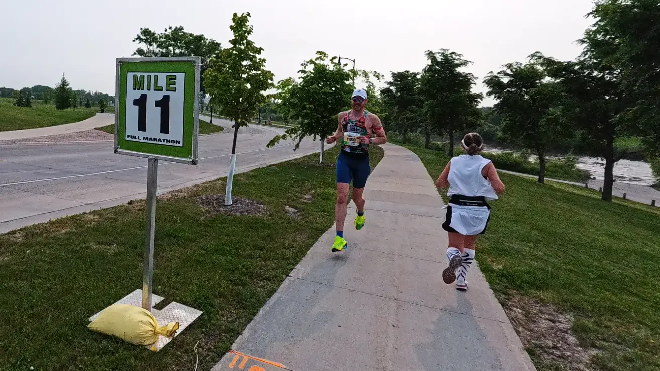 Mile 11 sign beside the sidewalk