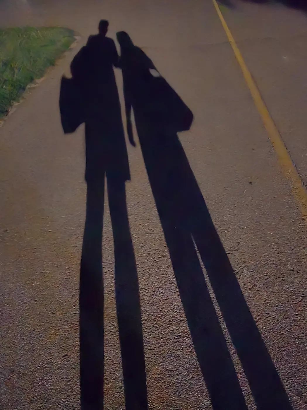 Long evening shadow on the sidewalk