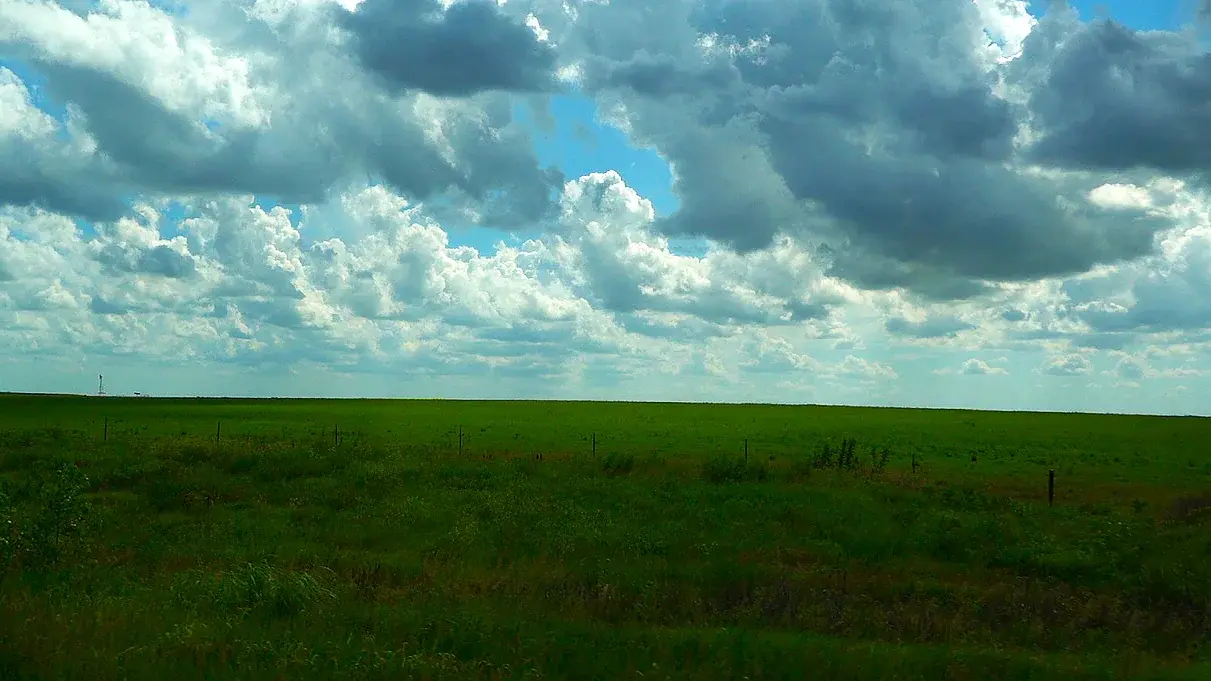 Clouds stacked over open prairie