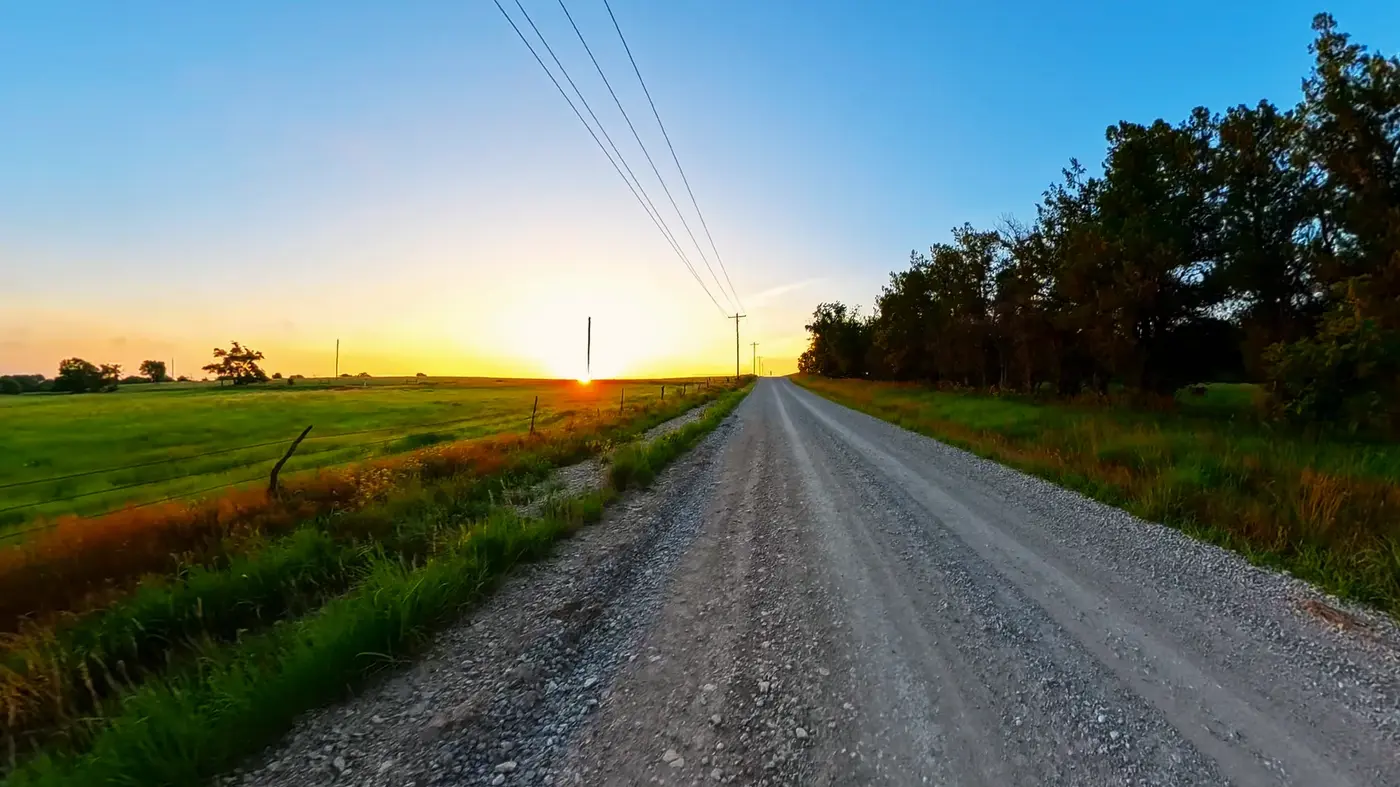 Long gravel road into the morning sun