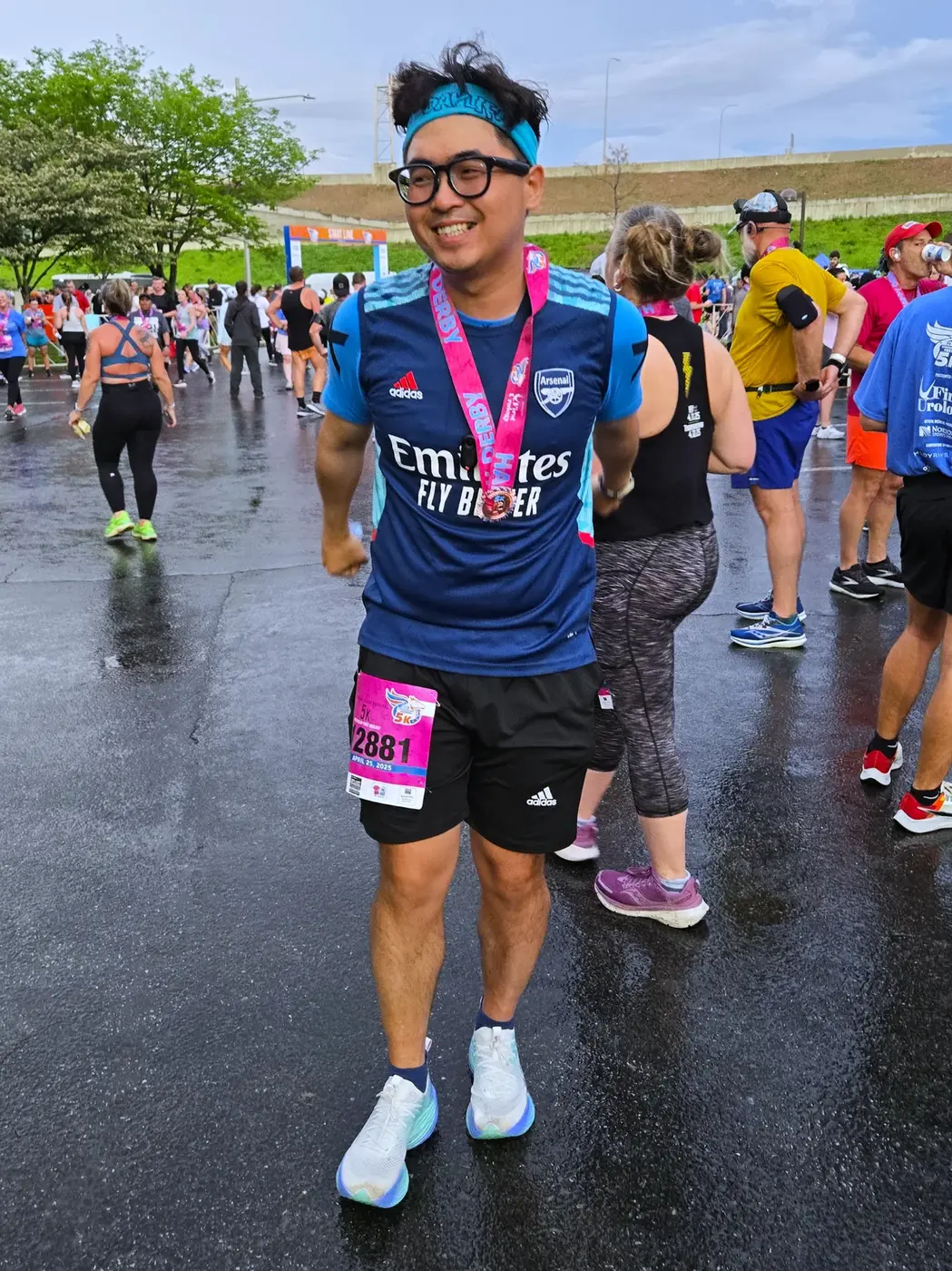 Post-5K medal pose in the rain