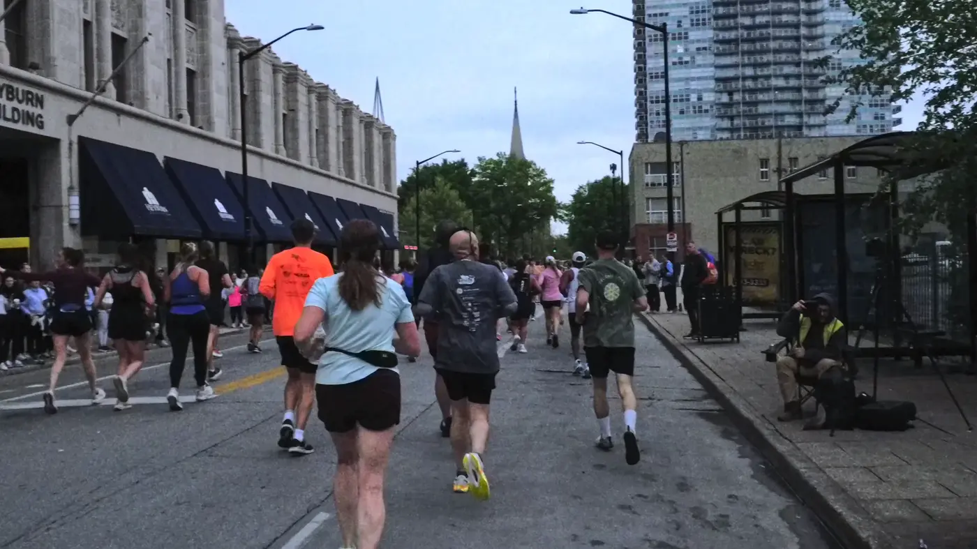 Runners turning through downtown streets