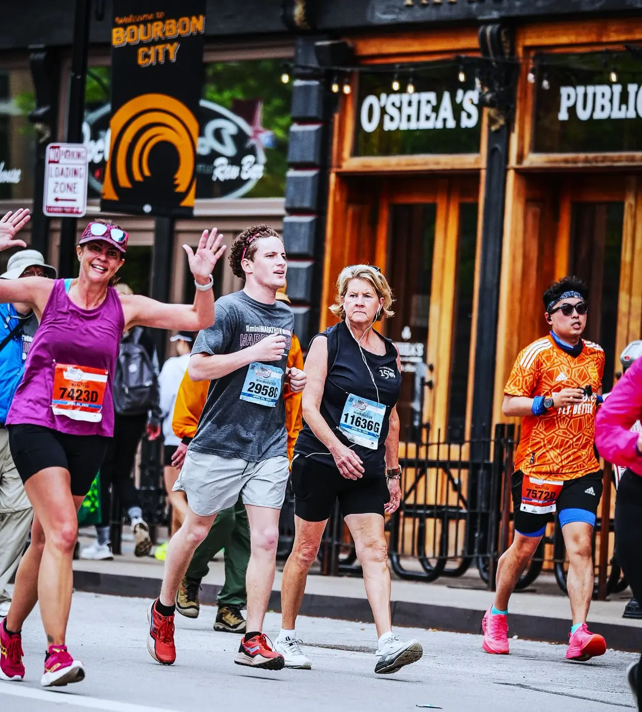 Runners passing the Osborne's storefront