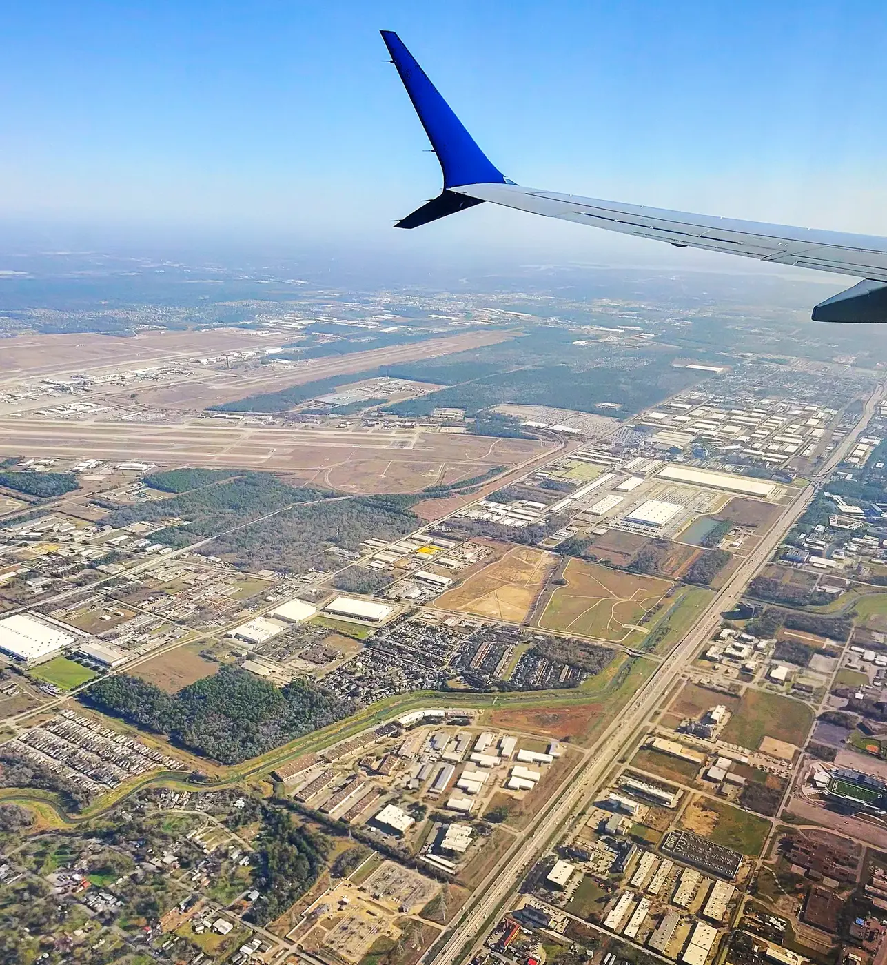 Wing view over the Houston suburbs