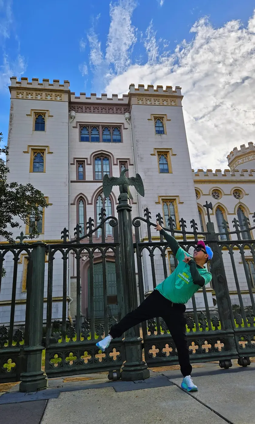 A quiet pose by the castle-like capitol fence