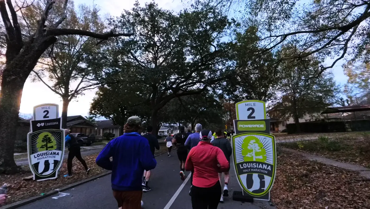 Mile 2 sign under oak branches