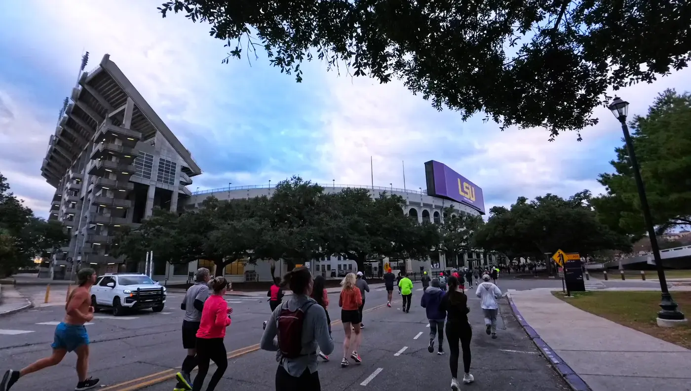Runners passing LSU buildings