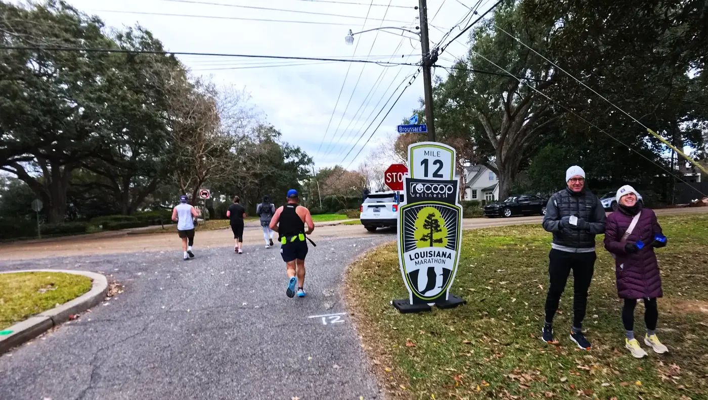 Mile 12 marker with spectators nearby