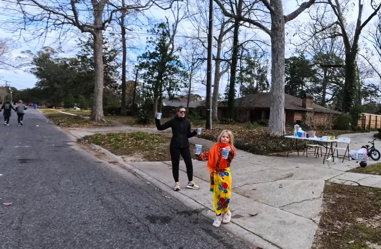 Families cheering from the sidewalk