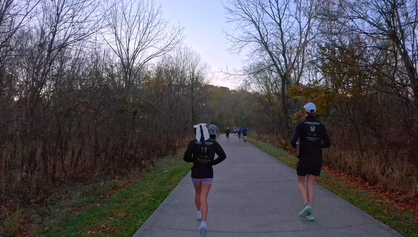 Running side by side on the wooded trail