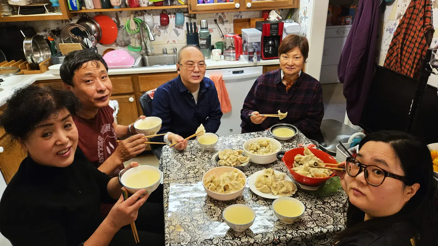 Family gathered around a Chinese dinner