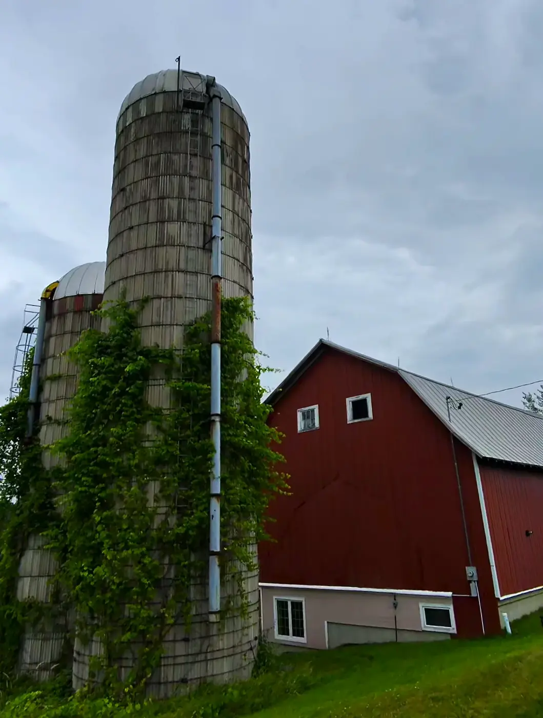 Tall silo beside a red barn