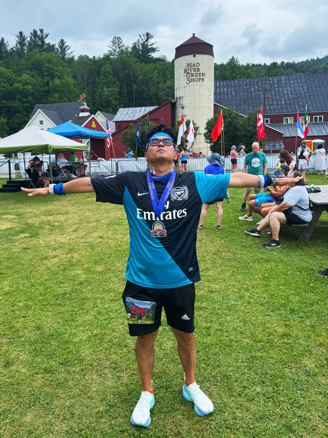 Full-body medal pose on the grass