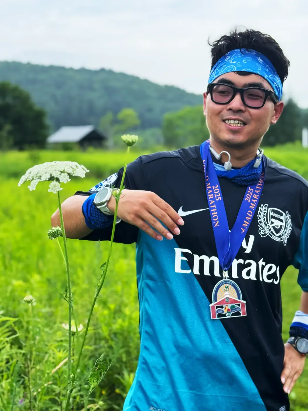 Close-up medal pose with the hills behind
