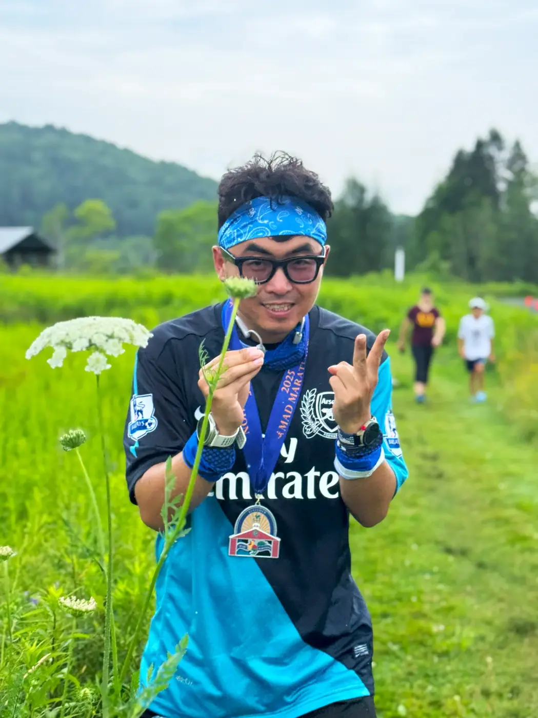 Medal and green valley behind the finish