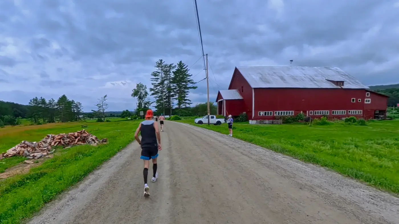 Runner passing the red barn