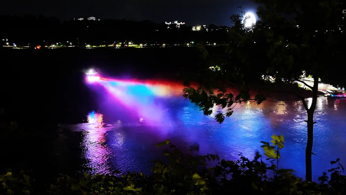 Color lights washing across the falls at