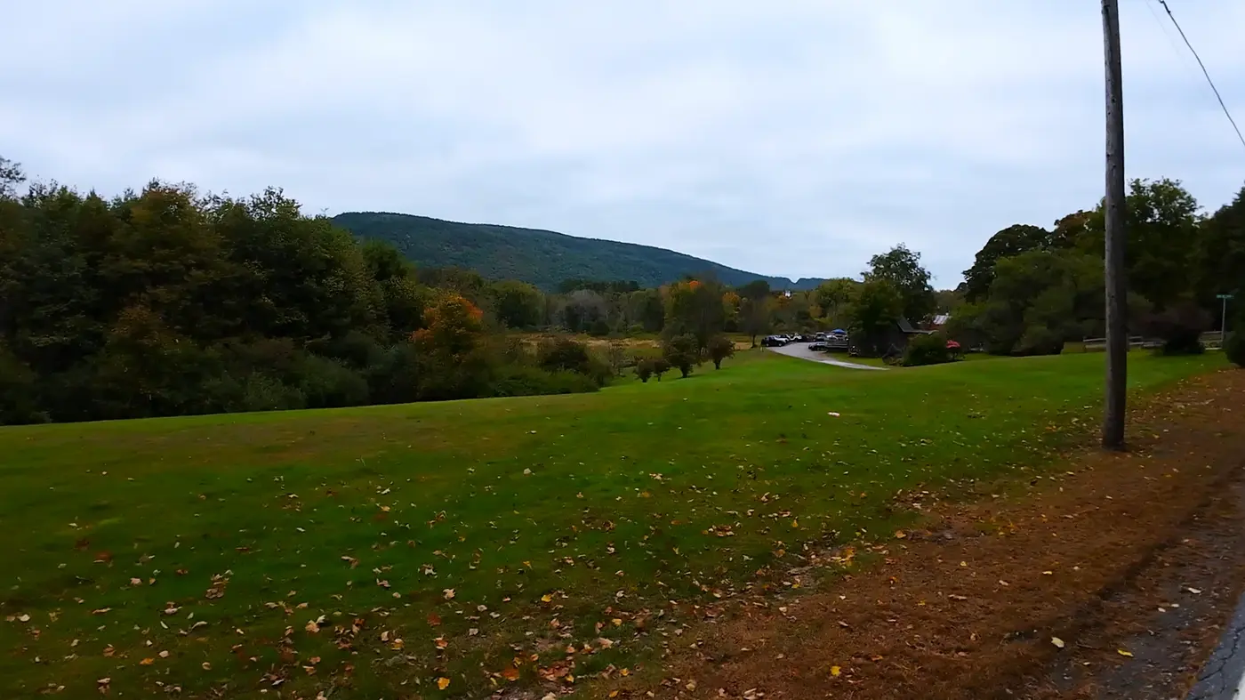 Open field and distant hills beside the