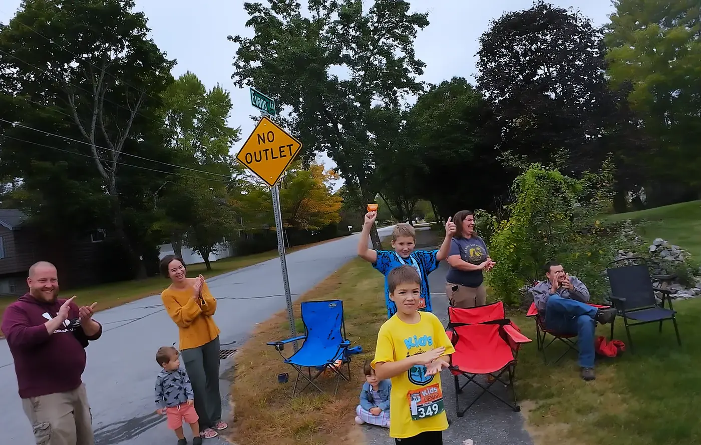 Neighborhood spectators cheering from the