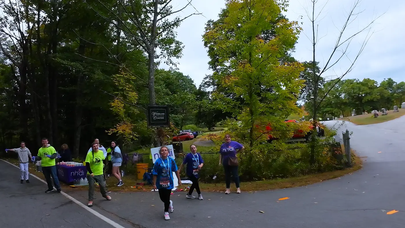 Runners entering the shaded cemetery road